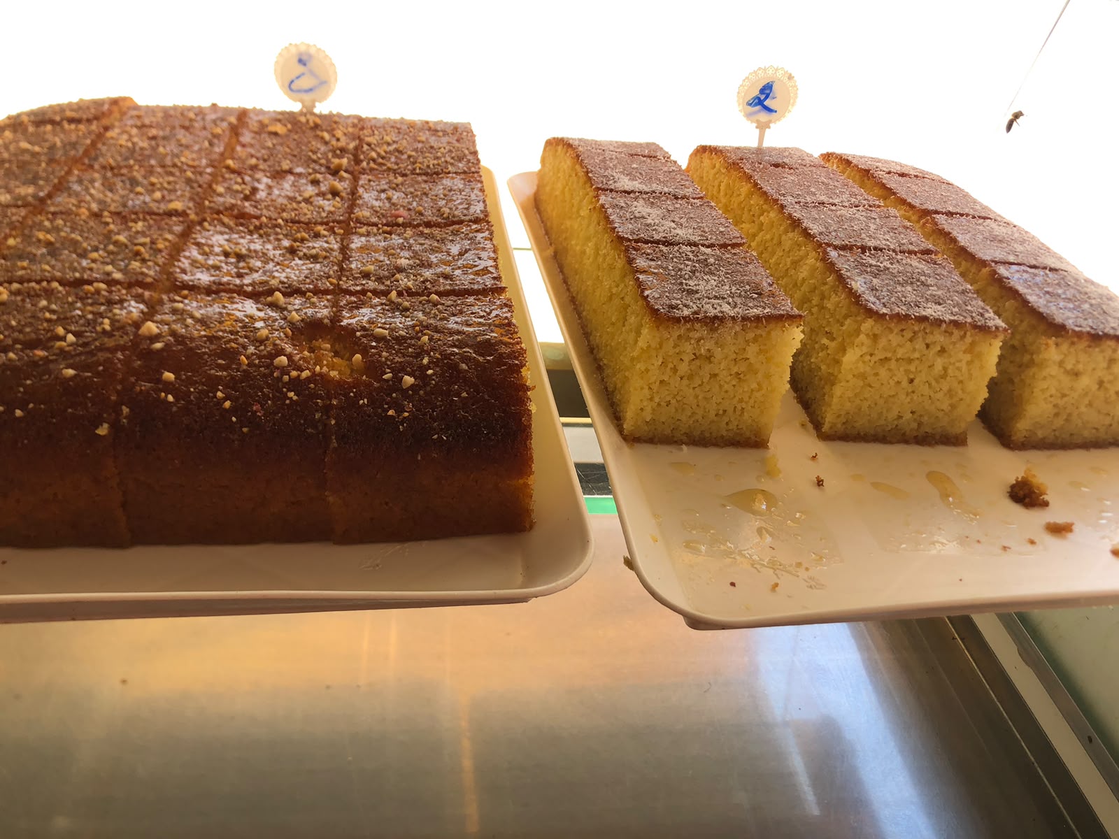 Fresh besbousa and sponge cake trays
